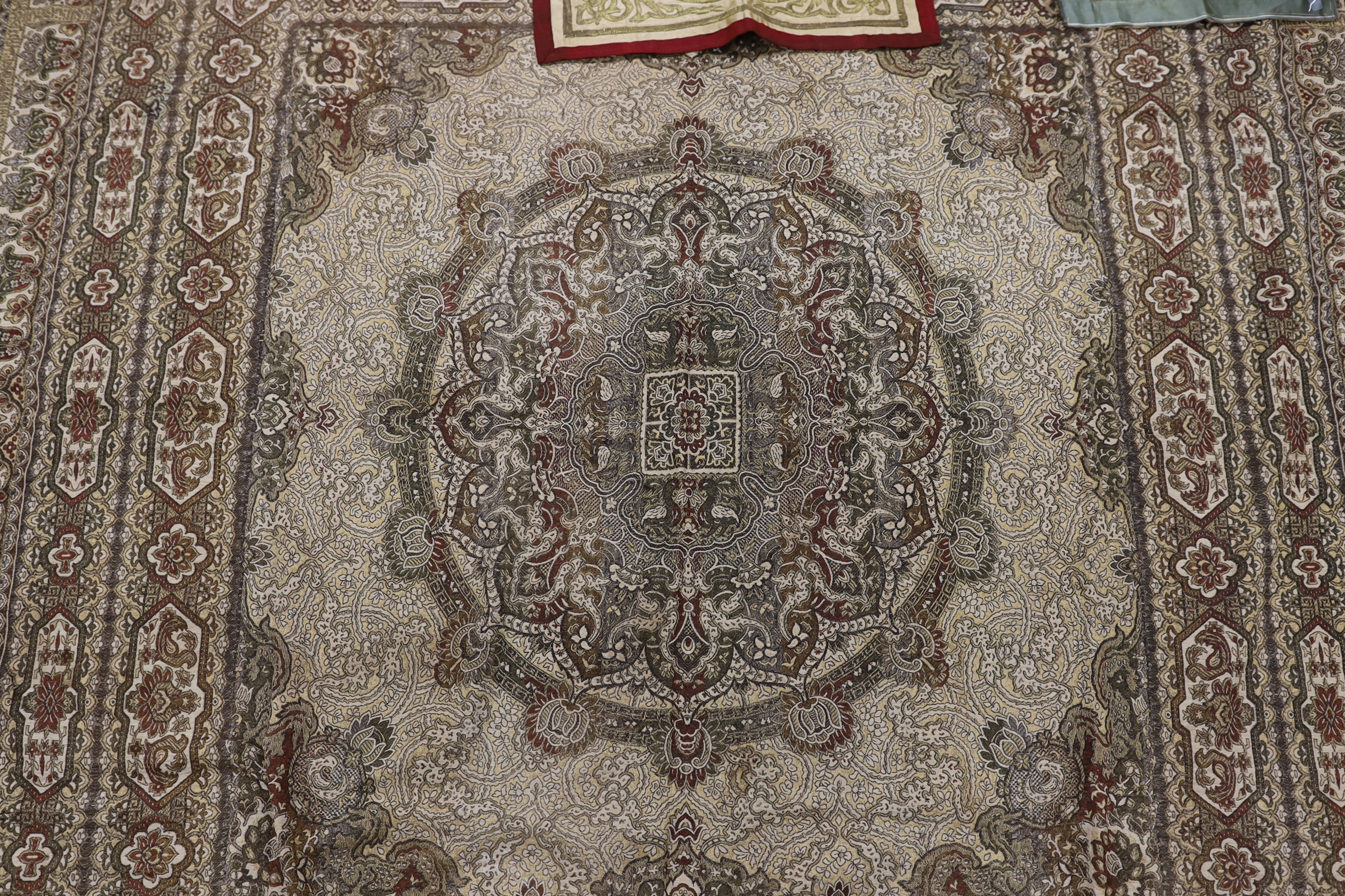 Two 19th century Indian heavy metallic thread embroideries on silk, another smaller similar panel and later 20th century machine woven fringed bedcover, two metal embroideries 53cm x 52cm
